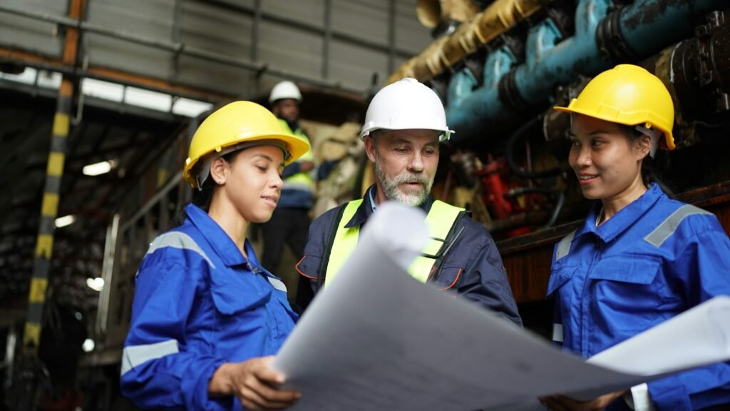 Portrait of engineer and apprentice in workshop of railway engineering facility