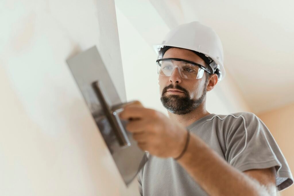 Professional craftsman applying plaster with a trowel