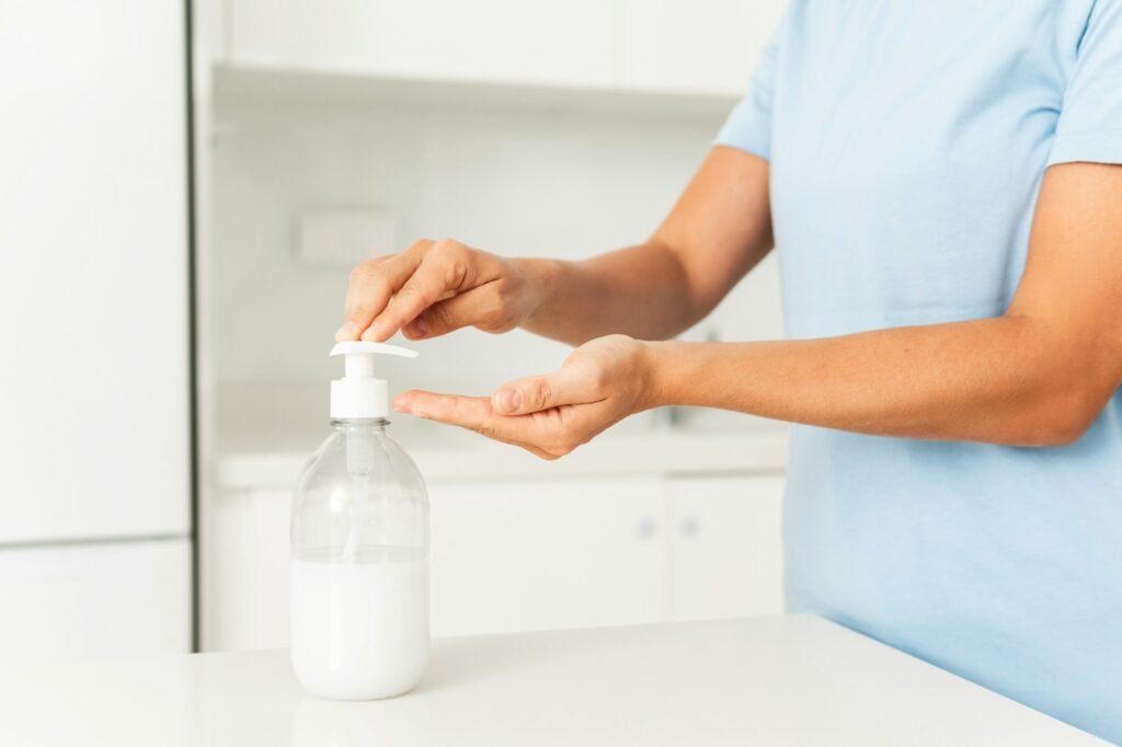 Woman using hand sanitizer or liquid soap for hands disinfection