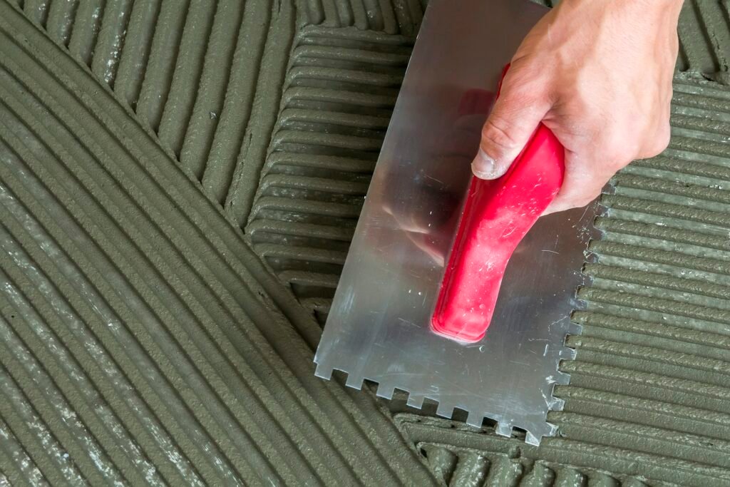 Close-up detail of floor tiles installation. Home improvement, renovation.