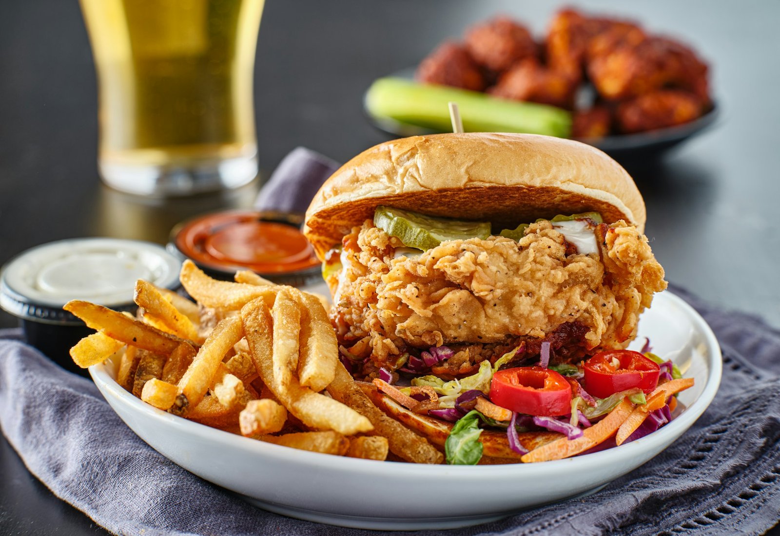 fried chicken sandwich with coleslaw and french fries