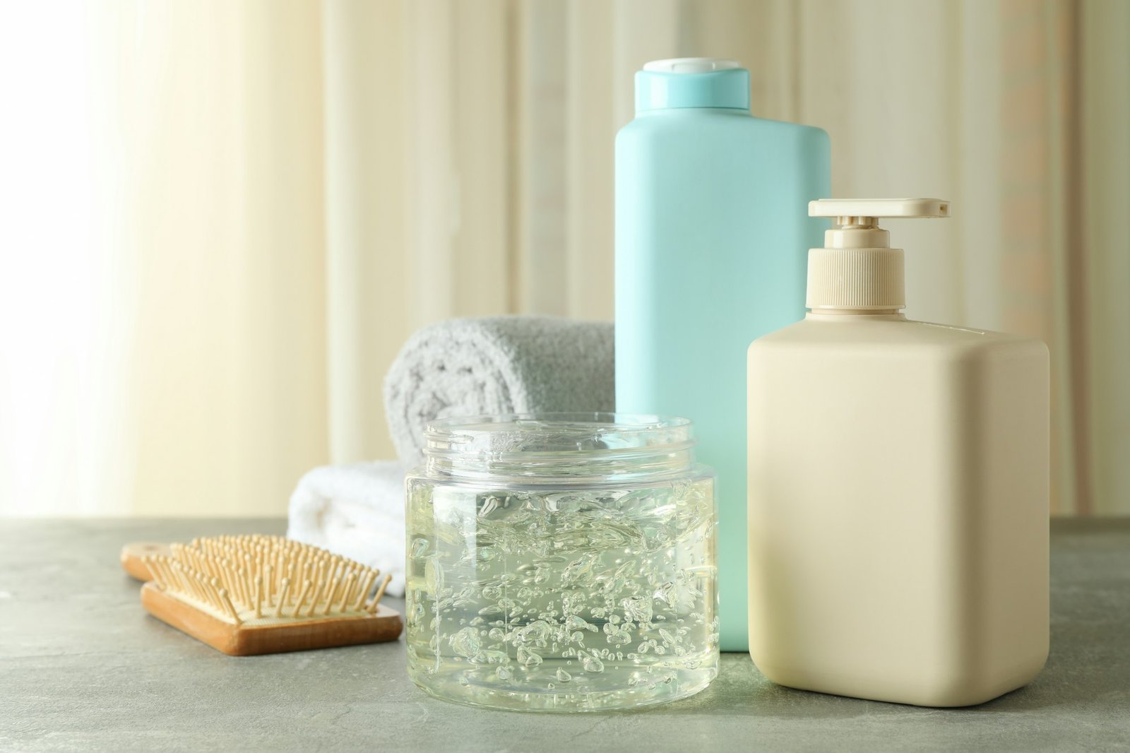 Hair care accessories on gray textured table