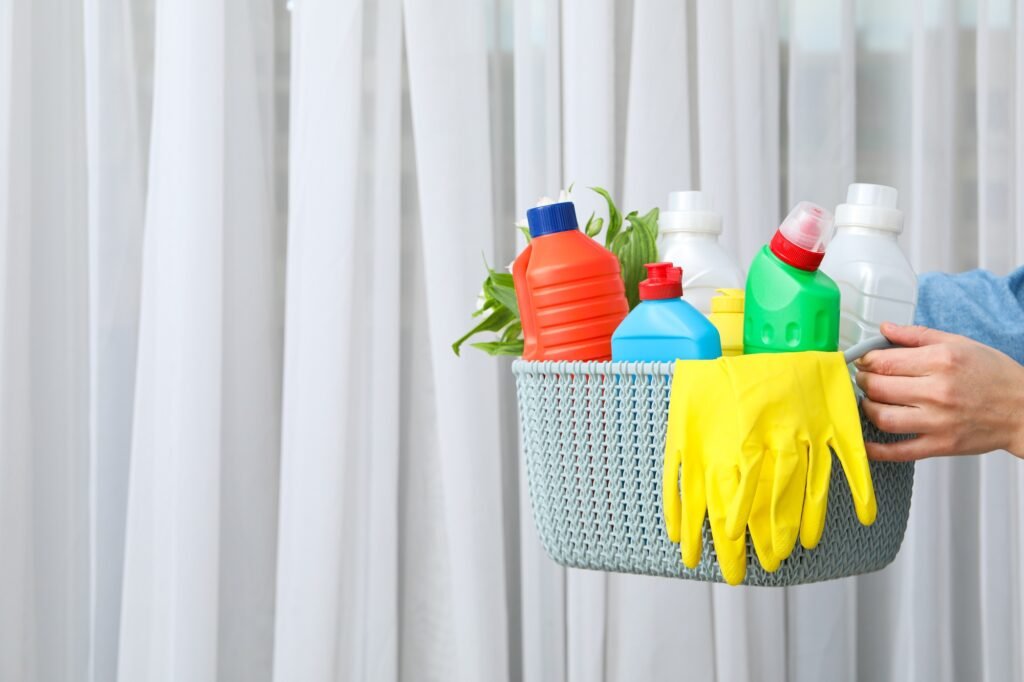 A basket with detergents in the hands of a woman