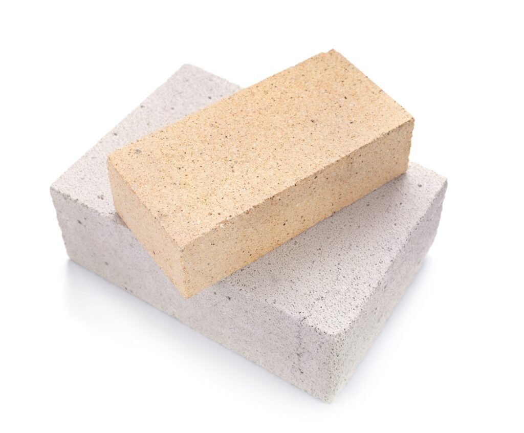 Aerated concrete block and cement brick isolated at white background